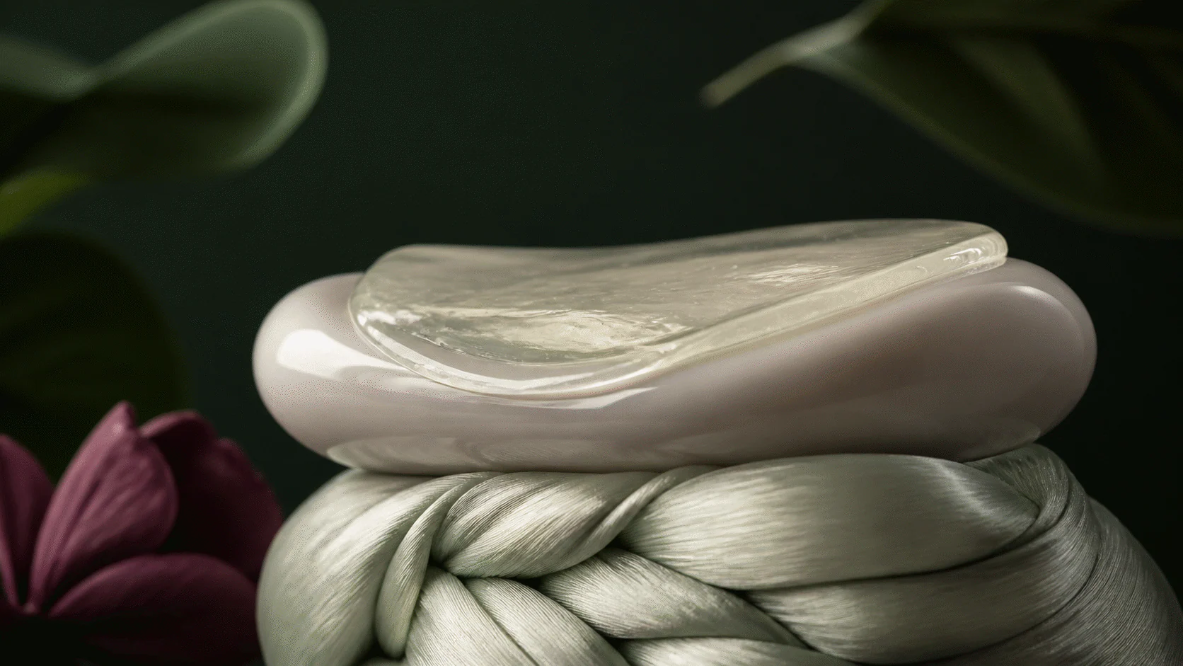Translucent gel film resting on pearl ceramic above a separate woven silver-silk structure.